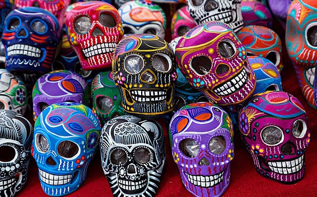 A pile of colorful skulls sitting on top of each other.